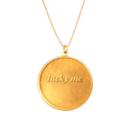 Gold coin pendant necklace engraved with Lucky Me, close-up front view on chain